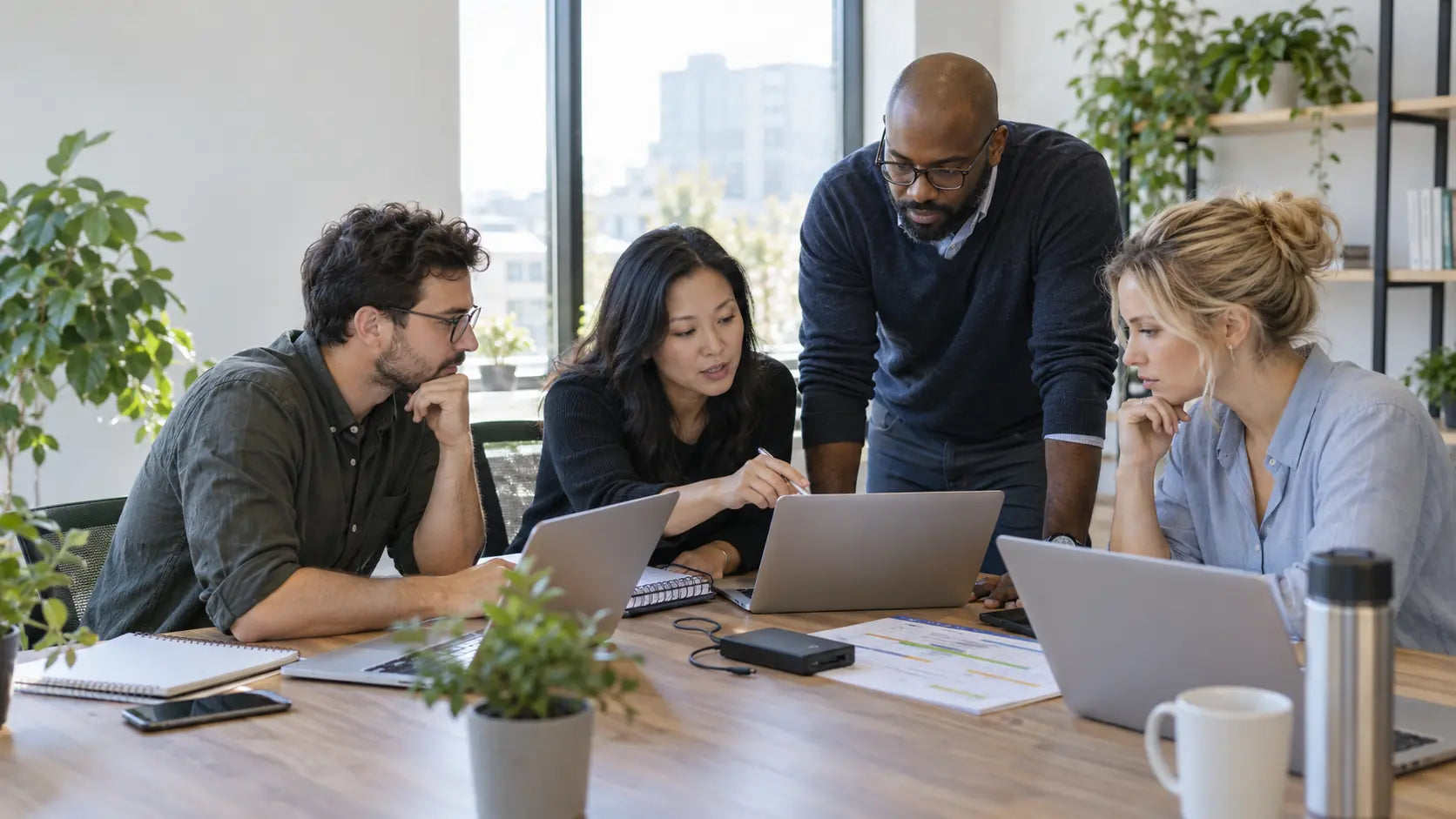 Business team planning a cloud workspace migration around a meeting table